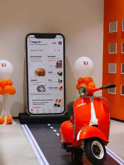 We designed this interactive photo booth for the Swiggy Annual Awards, featuring a giant smartphone display and their iconic orange scooter. It's a great example of how we integrate a company's brand identity into a fun and memorable experience for their employees.