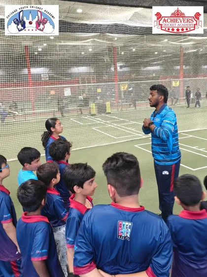 A back view of the coaching session, showing the engagement of the young cricketers at CYCA.