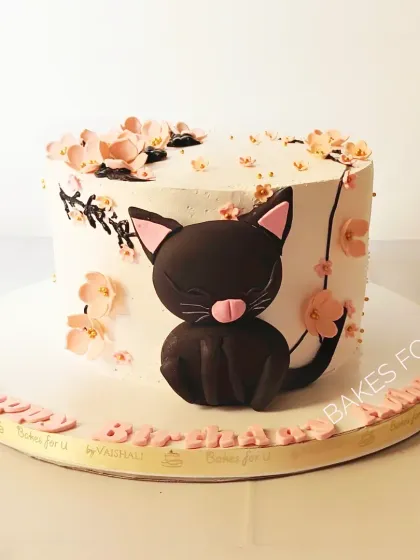 A cute cat-themed cake for a 10th birthday. The design features a sweet black cat surrounded by cherry blossoms, perfect for an animal lover.