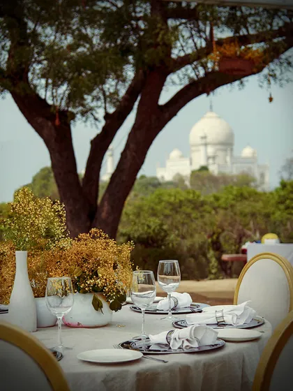 A closer look at the elegant table setting for our corporate event in Agra, with the Taj Mahal visible in the background. Every detail is considered to complement the grandeur of the setting.