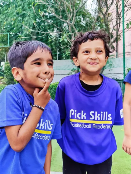Two of our youngest players sharing a fun moment. We believe in letting kids be kids, and their joy is our greatest measure of success.