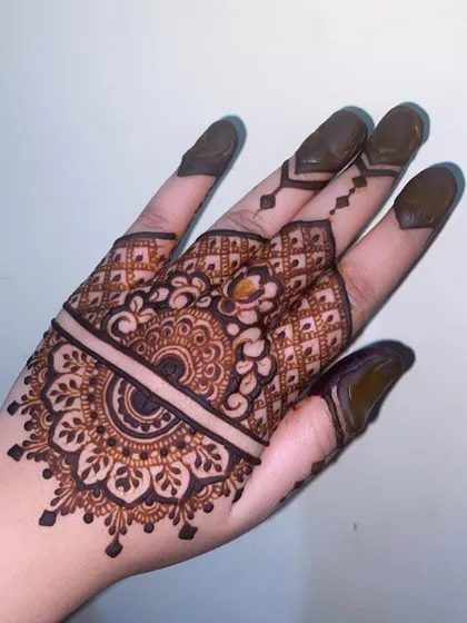 Another view of the half-mandala design, showcasing the intricate patterns on the fingers and the neat application.