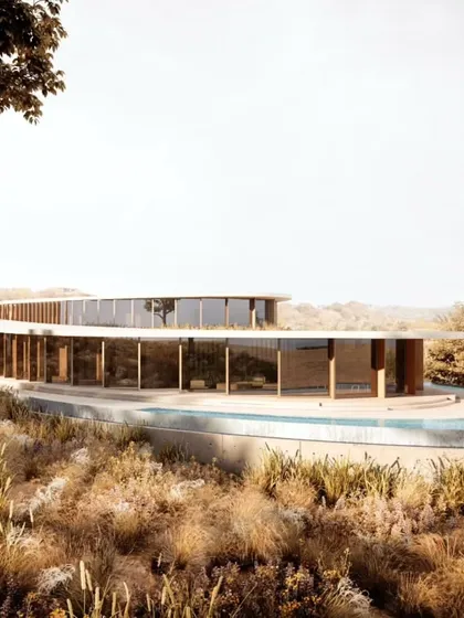 The full length of the villa's curved facade, showcasing its elegant integration with the hillside.