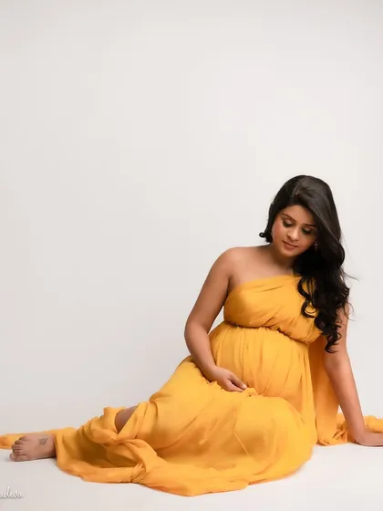 A quiet moment of connection, looking down at your bump. This pose is so full of love and tenderness.