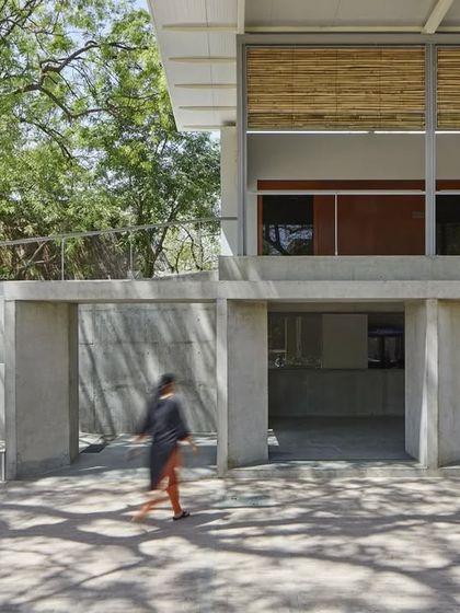 A view of the CEPT University Canteen showing the transition from the open ground floor to the lighter pavilion structure above. The design allows for flexibility, accommodating various uses over time.