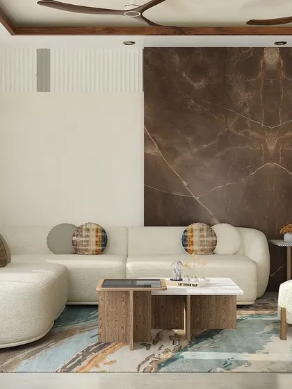 For this Gurgaon home, we designed an organic-themed living area. The custom L-shaped sofa with its rounded form is paired with a stunning Italian marble accent wall, creating a space that feels both modern and connected to nature.