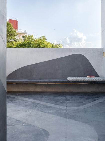 A once-bare office terrace now features a built-in bench with a fluid, painted backdrop. The design intervention softens the hardscape and encourages moments of pause and connection with the outdoors during the workday.