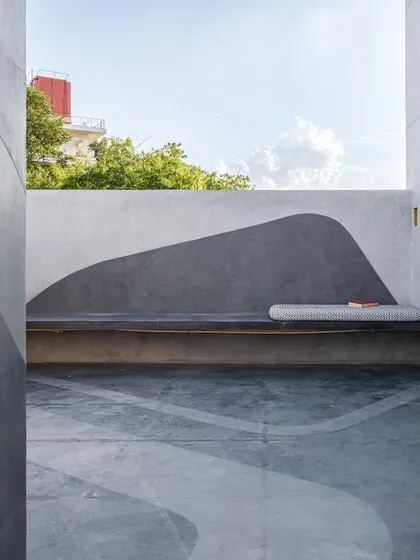 A once-bare office terrace now features a built-in bench with a fluid, painted backdrop. The design intervention softens the hardscape and encourages moments of pause and connection with the outdoors during the workday.