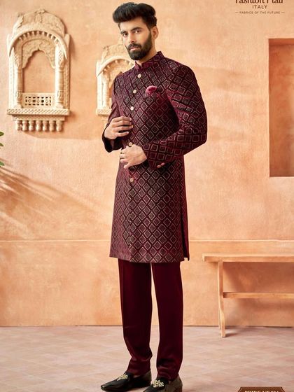 This Indo-Western sherwani in a deep maroon features a striking geometric pattern. It's a powerful and confident look, designed for grand entrances and memorable nights.