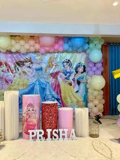 A royal celebration for Prisha! This Disney Princess theme features a beautiful pastel balloon backdrop and cutouts of all her favorite characters, creating a fairytale setting for her birthday.