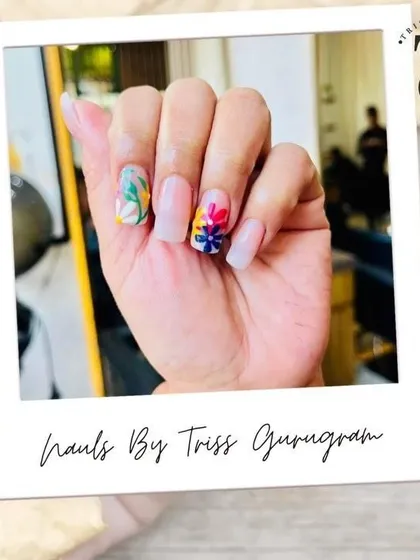 Another angle of my hand-painted floral nail art. This view shows the detail in the colorful blossoms on the accent nail, contrasted with the clean, natural look of the other nails.