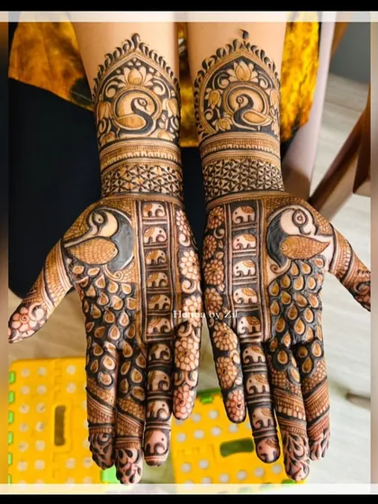 A unique design with rows of tiny elephants on the fingers and a large peacock on the palm.