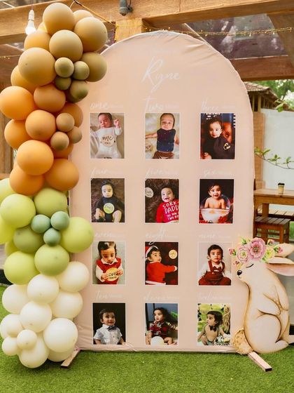 A 'journey through the first year' photo board for a woodland-themed birthday. This is a wonderful way to share precious memories with guests and makes for a beautiful and personal decor piece.