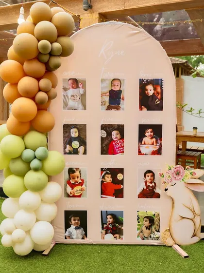 A 'journey through the first year' photo board for a woodland-themed birthday. This is a wonderful way to share precious memories with guests and makes for a beautiful and personal decor piece.