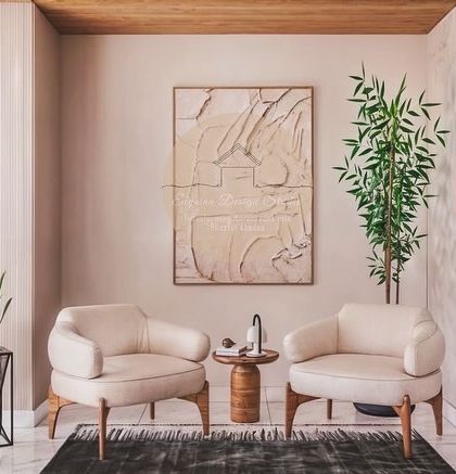 The lobby of a luxury office space we designed in Yelahanka, Bangalore. This waiting area features plush armchairs, textured walls, statement art, and indoor plants to create a sophisticated and welcoming environment for visitors.