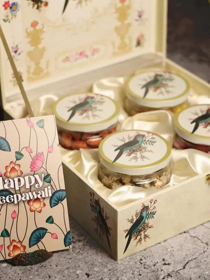 A cream-colored wooden box with a delicate bird motif. This design is timeless and can be adapted for many different occasions.