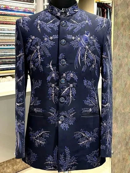 I love blending tradition with a personal touch. This custom navy blue bandhgala features delicate, hand-done bird and branch embroidery, creating a look that is both regal and unique for any formal occasion.