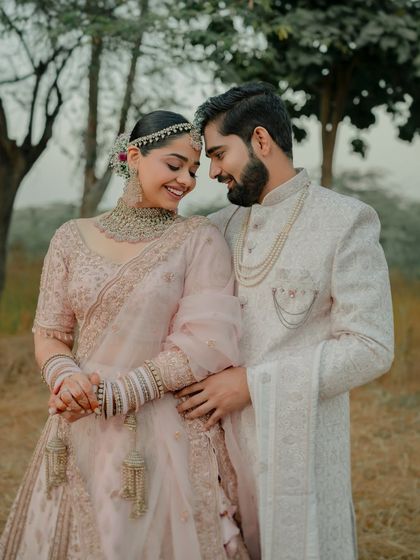 A sweet moment between the couple. Her soft glam makeup enhances her features, creating a look that is both beautiful and authentic.