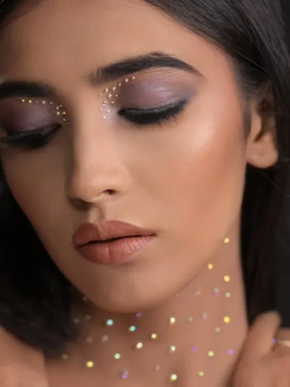 An eyes-closed shot that focuses on the delicate placement of the glitter on the eyelids.