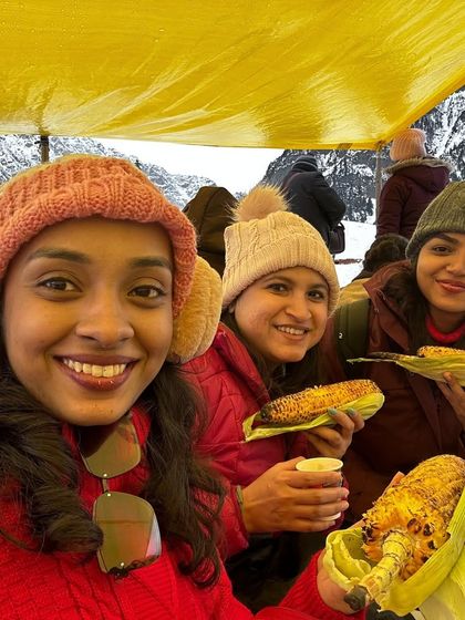 Enjoying roasted corn in the snow in Kashmir. It's the simple, local experiences that often make a trip truly memorable.
