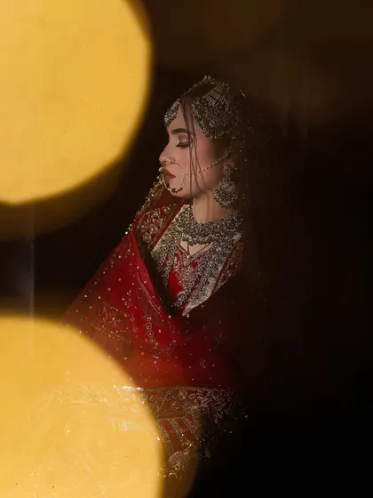 An artistic shot with beautiful lighting, creating a dreamy and dramatic effect. This shows how well the makeup translates in professional photography.