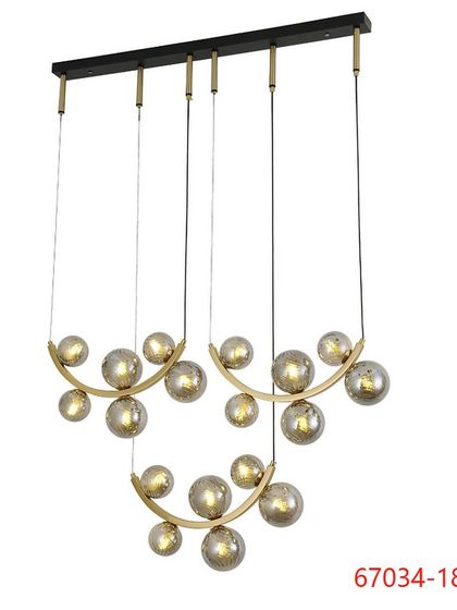 A multi-pendant chandelier featuring clusters of smoked glass globes on curved brass arms. This design is perfect for hanging over a long dining table or in a rectangular room.