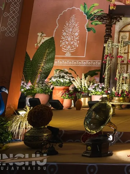 Details from the South Indian village-themed naming ceremony. We used hand-painted murals, peacock figures, and traditional brass lamps to create a rich and authentic atmosphere.