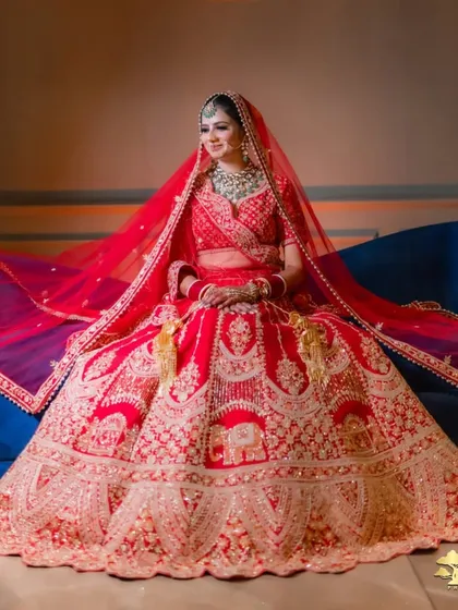 Every bride deserves to feel like royalty. This full-length bridal portrait captures the intricate details of the lehenga and the bride's graceful posture, creating a timeless and elegant image.