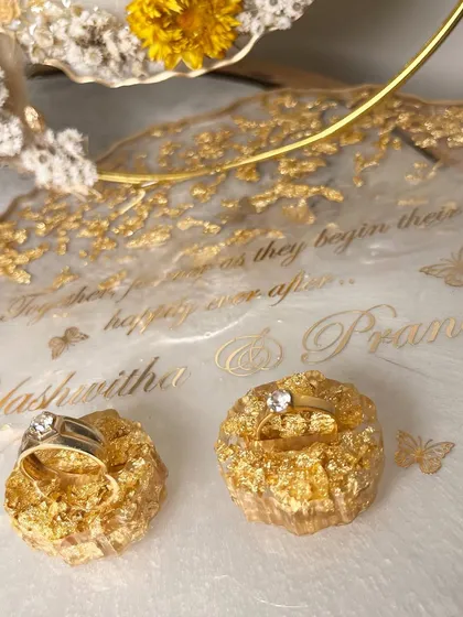 A detailed shot of the custom ring holders, filled with gold leaf to match the platter's accents.