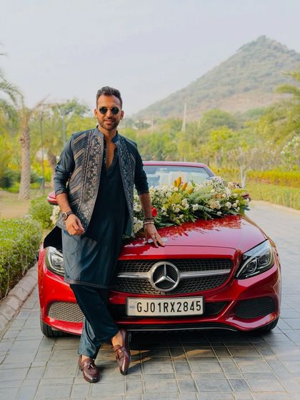 Another shot from the baraat-ready photoshoot. My look, featuring a designer kurta and jacket, complements the festive and luxurious feel of a grand Indian wedding.
