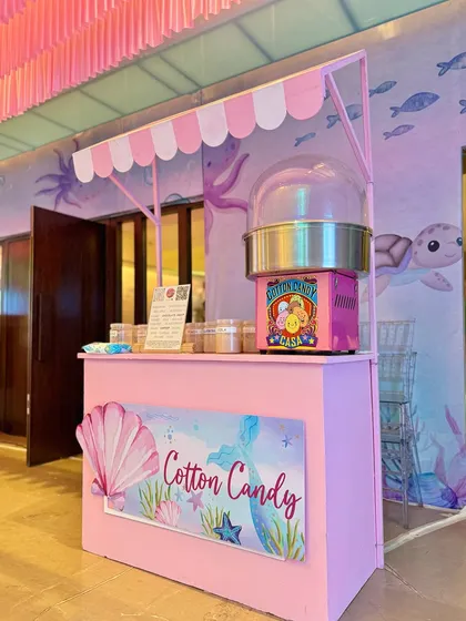 From a pastel soft play area and a cotton candy cart to a buffet with an LED screen backdrop showing aquatic life, every element was designed to immerse guests in Miraya's mermaid world.