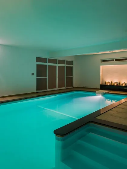 Luxury is an experience of serenity. This indoor swimming pool, designed for a 10,000 sq. ft. Bangalore residence, uses subtle underwater and ambient lighting to create a private oasis for relaxation and wellness, perfectly juxtaposed with the home's simple, clean lines.