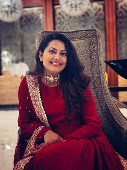 Priyanka Barve looking graceful and happy in the red Anarkali, a perfect example of festive celebrity styling.