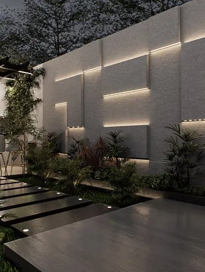 The architectural wall with integrated backlighting serves as a stunning feature in this terrace design. It provides ambient light and visual interest, guiding the path towards the modern bar and kitchen area.