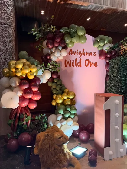 A 'Wild One' first birthday party comes to life with a custom backdrop, themed balloon garlands, and safari animal props. We specialize in bringing popular kids' party themes to life with creative and detailed setups.