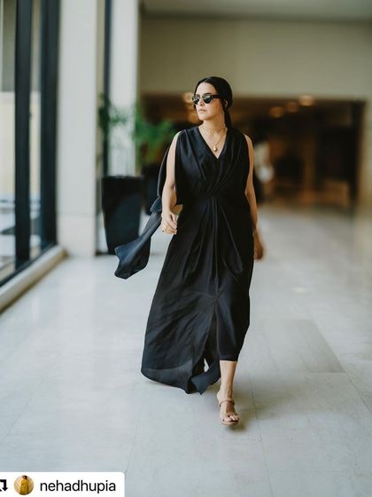 Neha Dhupia walking through the venue. This shot shows how the hairstyle moves and holds up in a real-world event setting, looking polished and secure.