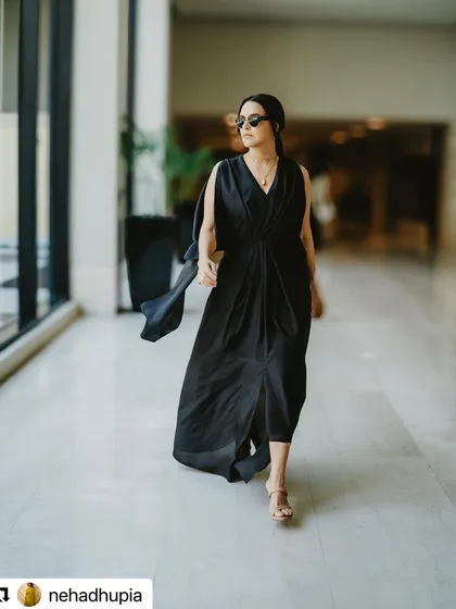 Neha Dhupia walking through the venue. This shot shows how the hairstyle moves and holds up in a real-world event setting, looking polished and secure.