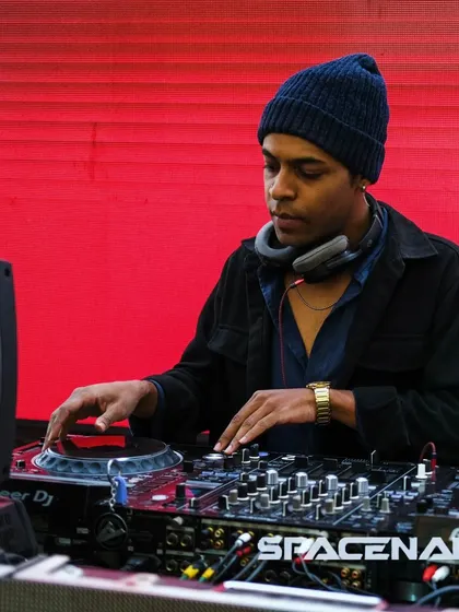 Focused on the mix, ensuring every transition is seamless. Here I am at the decks, using my Pioneer setup to craft the sound for the night.