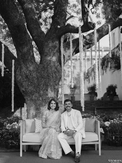 A classic black and white portrait of Himmat and Ineka. The simplicity of the composition and the natural setting create a feeling of timeless elegance.