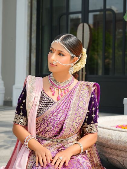 A candid moment of the bride looking away. Her makeup is flawless from every angle, with a beautiful highlight on her cheekbones and a classic winged liner.