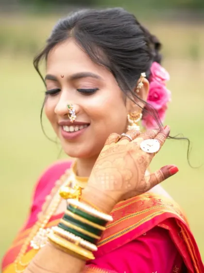 A playful, candid moment that highlights the bride's beautiful smile and the fresh, natural makeup.