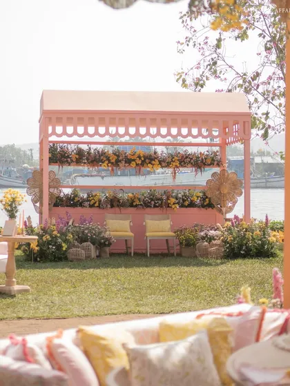 A pink floral cabana provides a beautiful photo backdrop and a shaded seating spot right by the river.