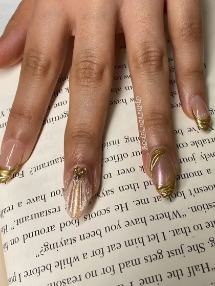 Another look at the gold-wrapped nails, this time against a book. Even in a simple setting, they look incredibly luxurious.