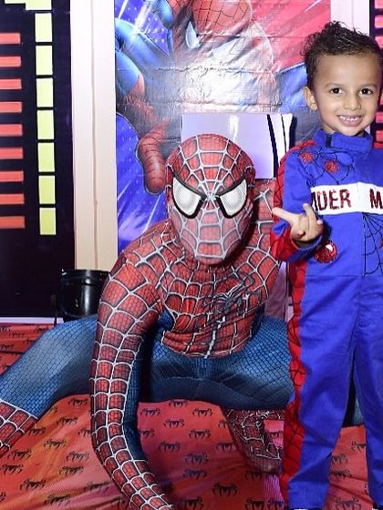 The birthday boy posing with his hero, Spider-Man. Arranging for a character mascot to interact with the kids is one of the best ways to make the theme feel real and create unforgettable photo opportunities.