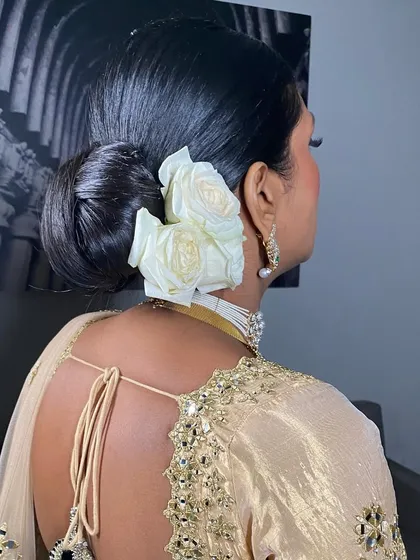 You can never go wrong with a classic. This is a sleek, polished bridal bun I created, adorned with fresh white roses for a look of pure elegance and sophistication.
