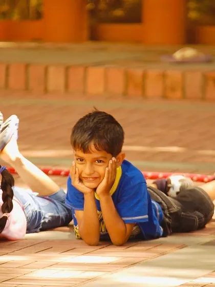 A moment of rest and happy smiles after a challenging round of tug-of-war. It's important to balance high-energy games with moments of calm, allowing kids to recharge and connect.