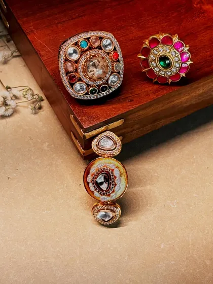 Three of our most artistic rings, showcasing the variety in design, from multi-gemstone settings to delicate enamel work.