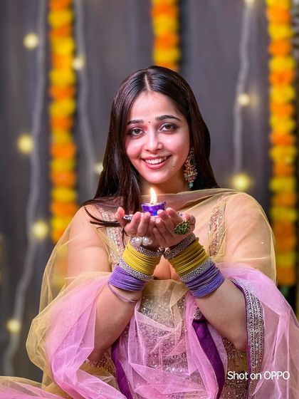 A festive portrait of a woman holding a lit diya (oil lamp) for Diwali. This was part of a collaboration, showcasing how to capture beautiful portraits during festivals.