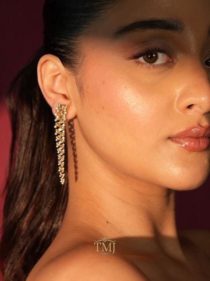 The Tornado Earring, seen here on a model, shows how this unique spiraling design elegantly frames the face and adds a touch of modern drama.