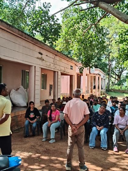 Instructors address a group of students at the start of a climbing day, ensuring everyone is prepared and understands the safety guidelines.